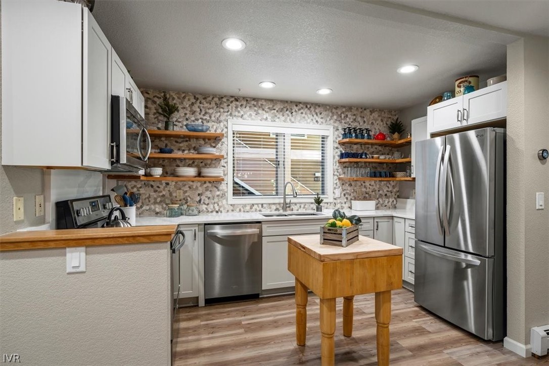 947 Incline Way, Unit 172 Incline Village, NV 89451 - Photo 11 of 30 a kitchen with stainless steel appliances granite countertop a refrigerator a sink dishwasher a stove and a refrigerator with wooden floor