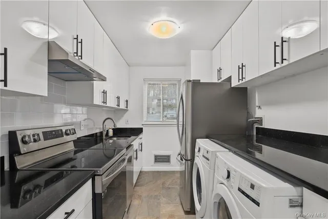 a kitchen with stainless steel appliances granite countertop a sink stove and refrigerator