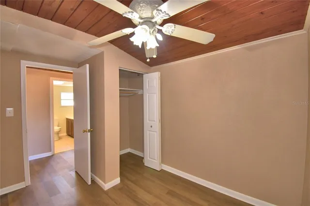 a bathroom with a granite countertop sink mirror vanity and a toilet