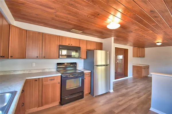 a kitchen with granite countertop stainless steel appliances and wooden cabinets