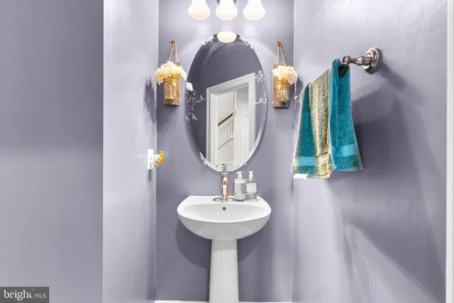 a bathroom view with sink and mirror