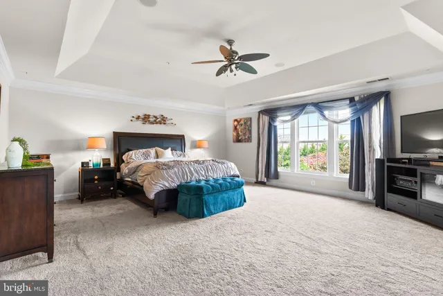 a bedroom with a bed and a television