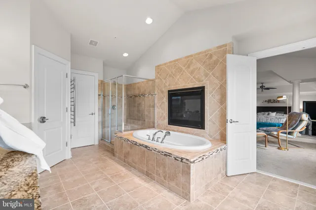 a spacious bathroom with a tub sink and mirror