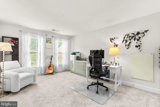a view of a livingroom with workspace and a couch