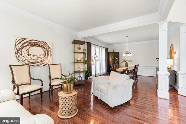 a living room with furniture a fireplace and wooden floor