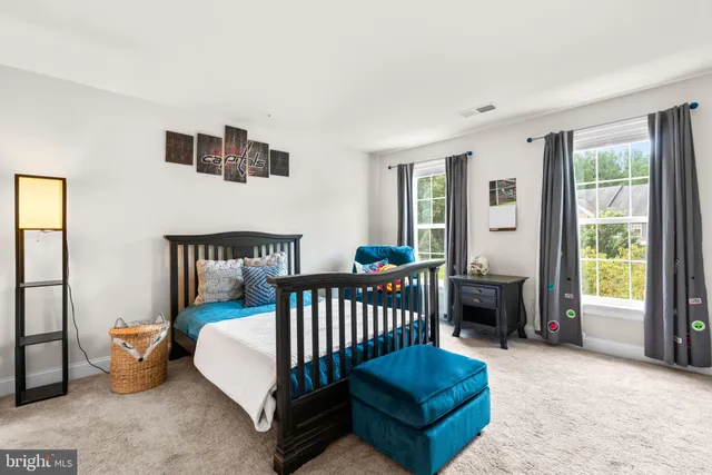 a bedroom with furniture and a window