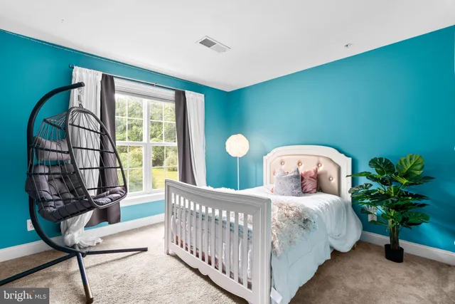 a bedroom with furniture and a window