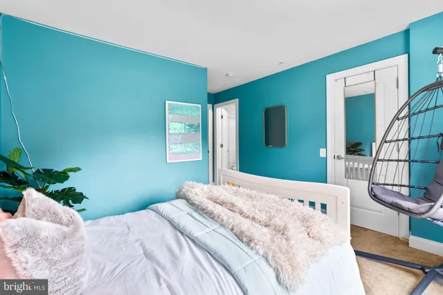 a bedroom with a bed and a dresser