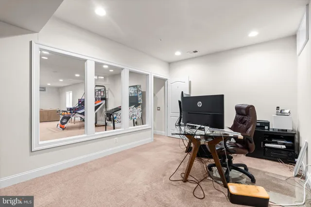 a view of a workspace with furniture and wooden floor