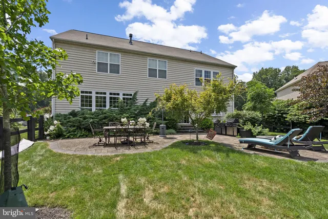 a view of a house with backyard sitting area and garden