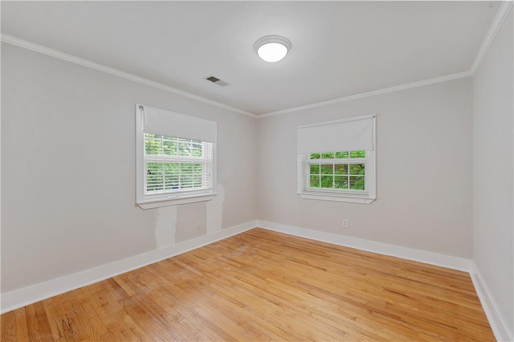 866 Briarcliff Road Northeast, Unit B3 Atlanta, GA 30306 - Photo 11 of 17 an empty room with wooden floor and windows