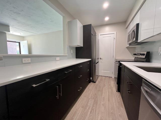 11 Shore Road, Unit 5D Somers Point, NJ 08244 - Photo 5 of 15 a spacious kitchen with a sink and cabinets