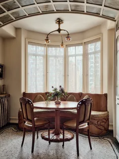 a view of a dining room with furniture and window