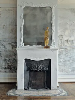a fireplace with a vase on top of it