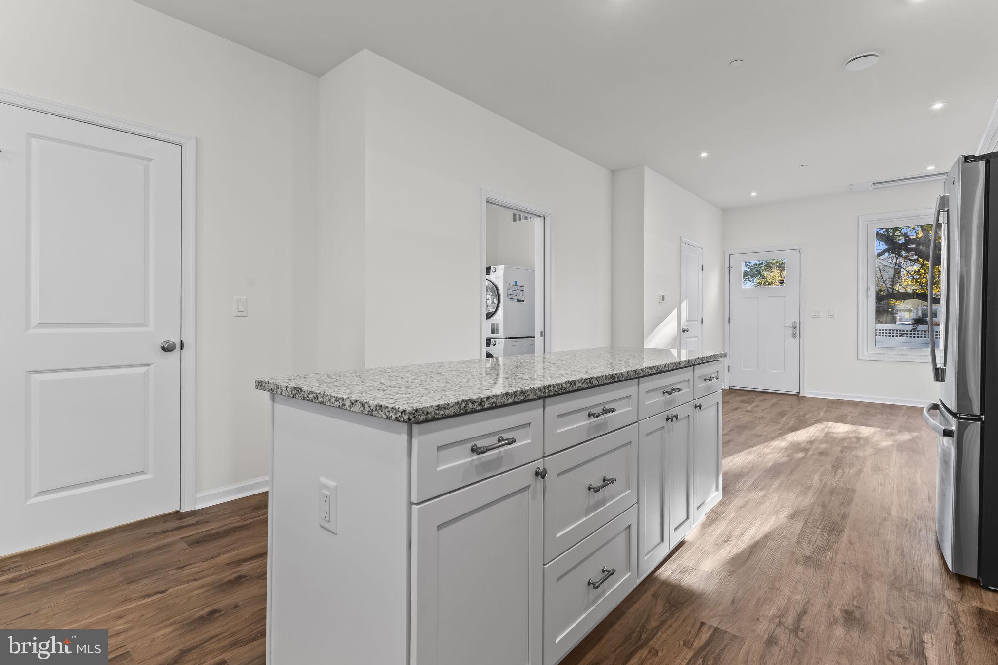 721 60th Place Capitol Heights, MD 20743 - Photo 12 of 33 a spacious bathroom with a granite countertop sink and a mirror