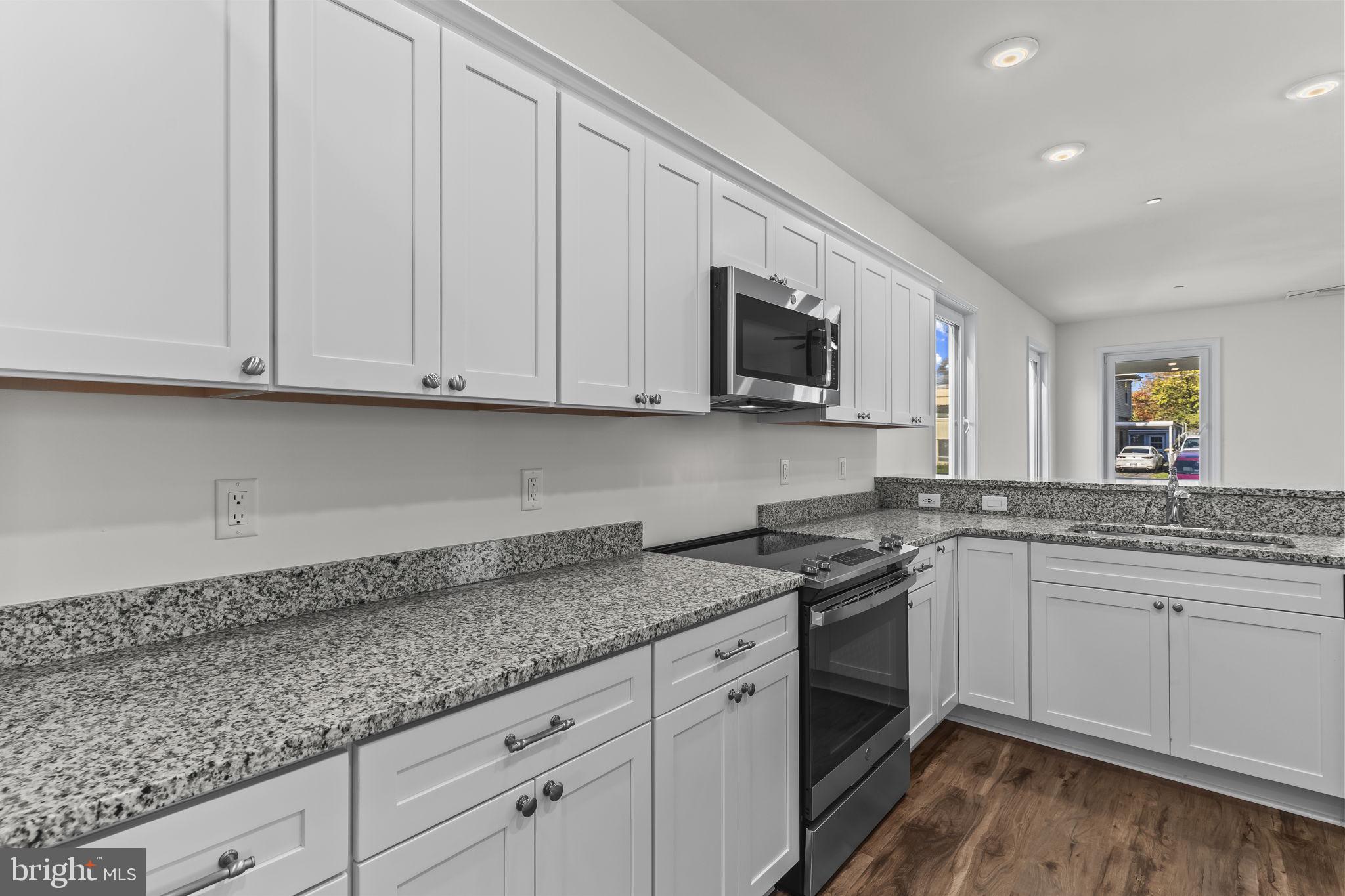 721 60th Place Capitol Heights, MD 20743 - Photo 14 of 33 a kitchen with granite countertop white cabinets and a sink