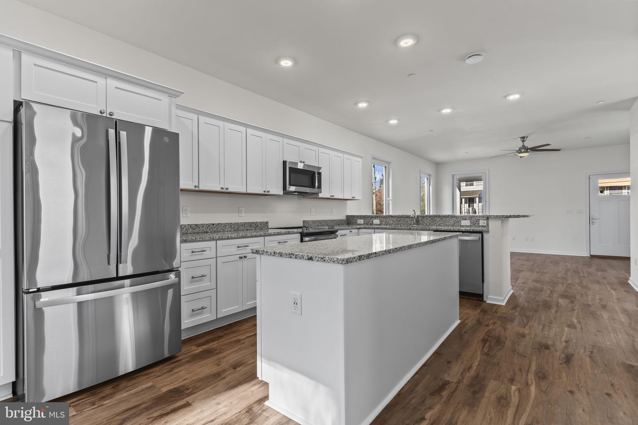 721 60th Place Capitol Heights, MD 20743 - Photo 15 of 33 a kitchen with granite countertop a refrigerator stove and sink