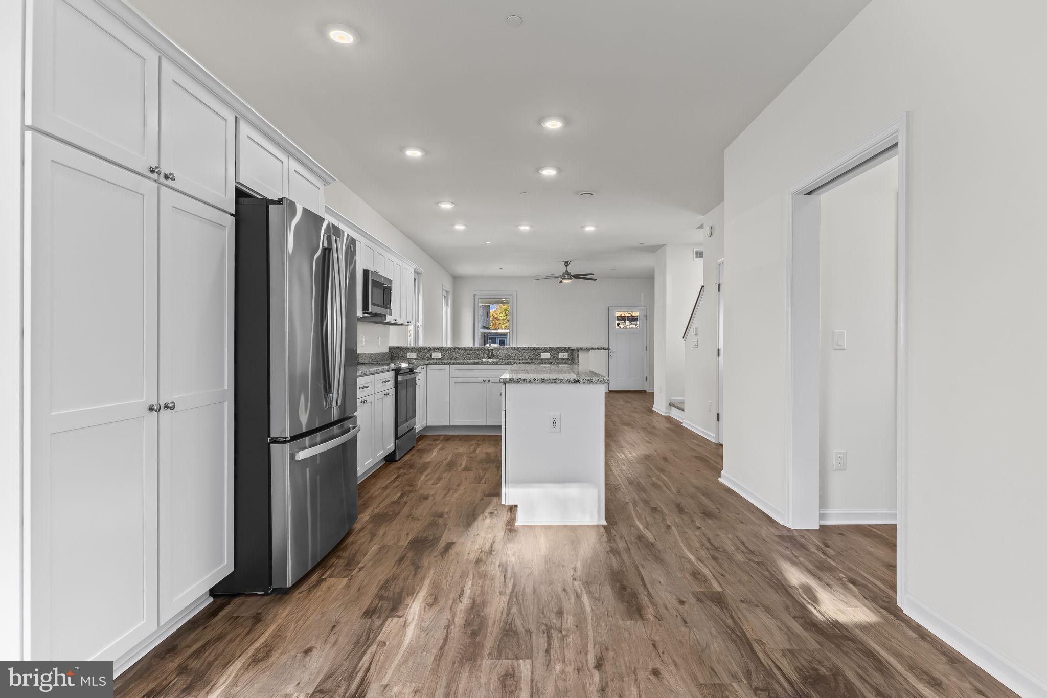721 60th Place Capitol Heights, MD 20743 - Photo 16 of 33 a kitchen with stainless steel appliances granite countertop a refrigerator and a stove top oven