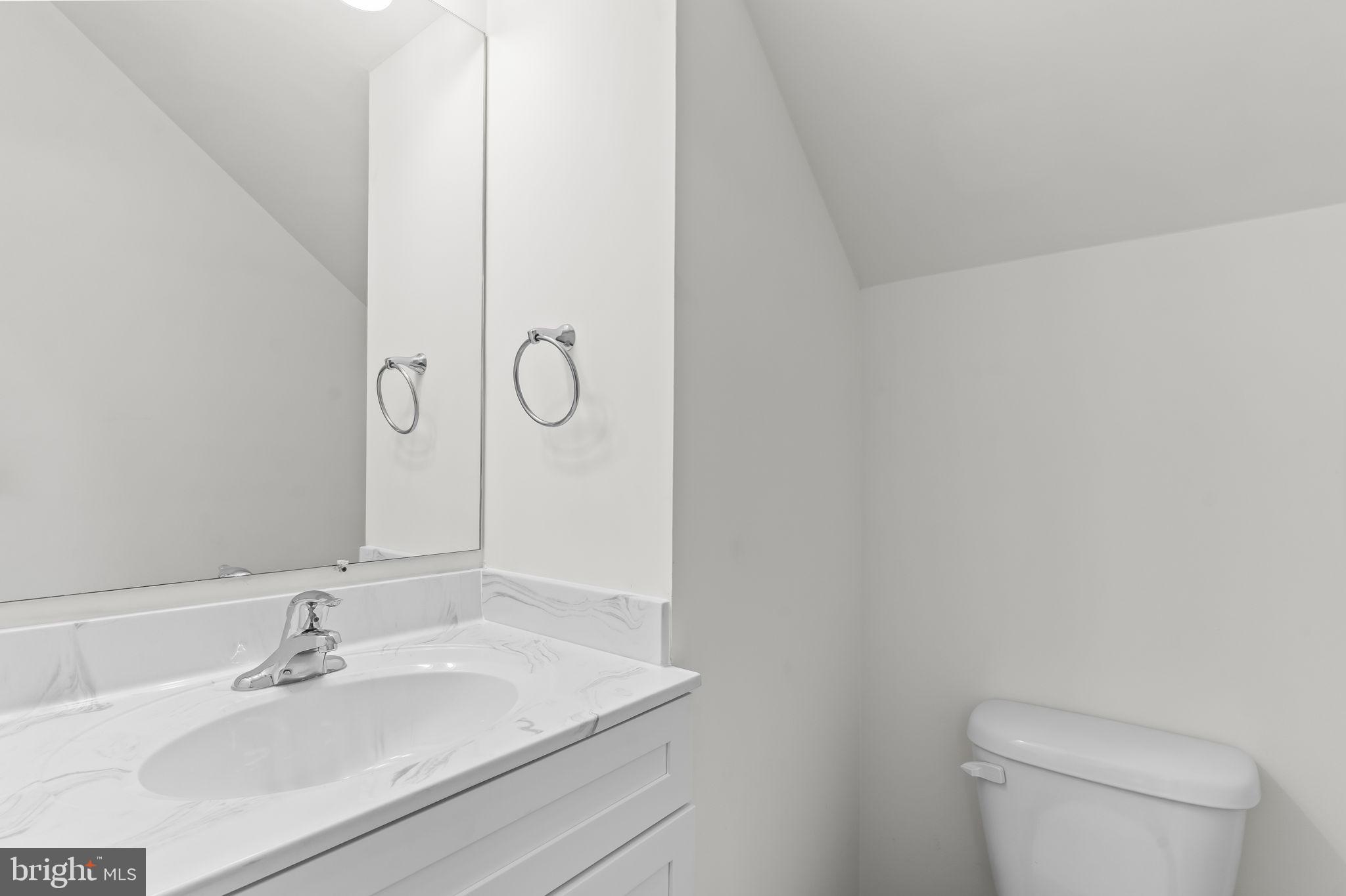 721 60th Place Capitol Heights, MD 20743 - Photo 20 of 33 a bathroom with a sink a toilet and a mirror