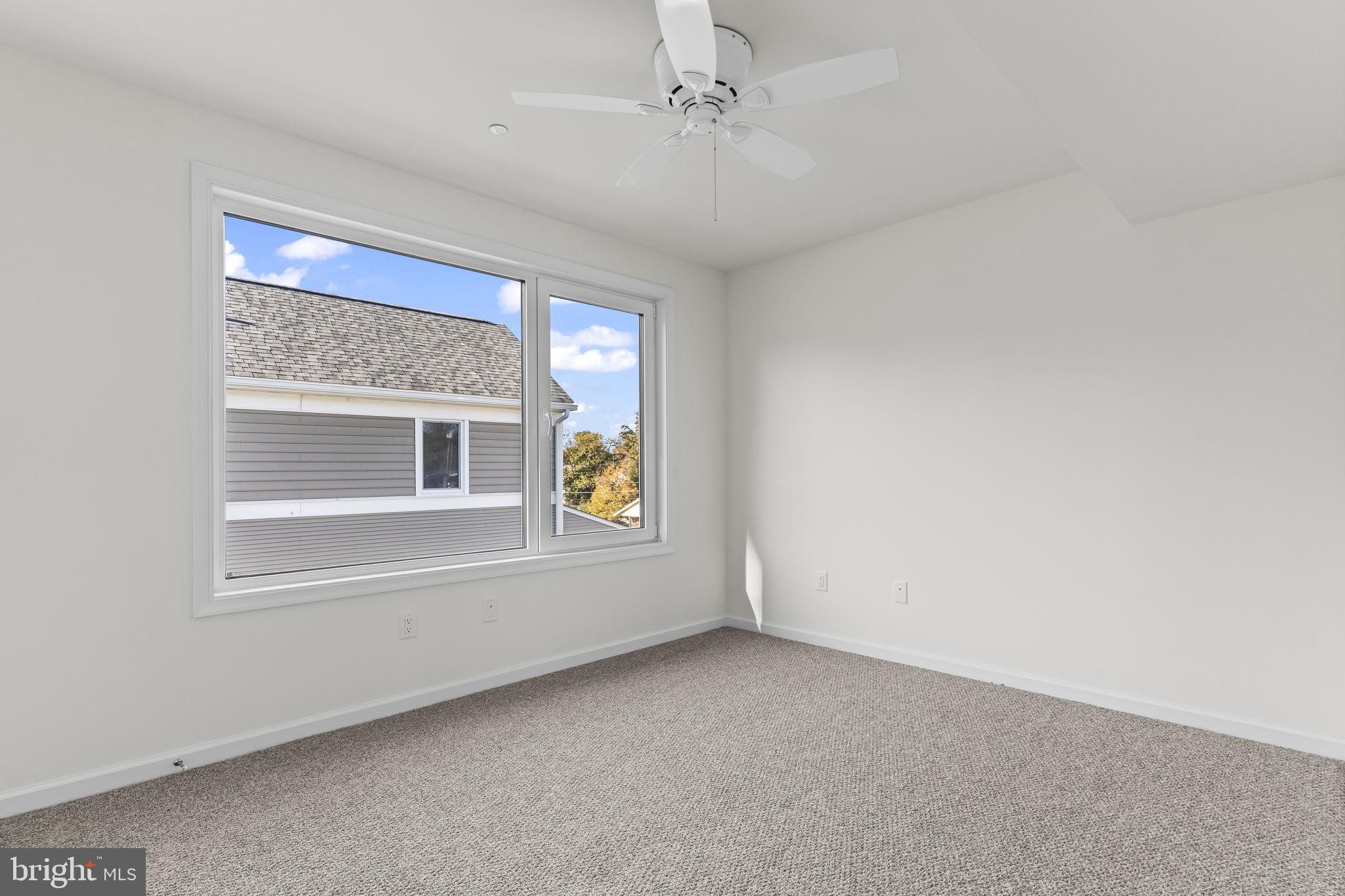 721 60th Place Capitol Heights, MD 20743 - Photo 28 of 33 an empty room with windows and ceiling fan