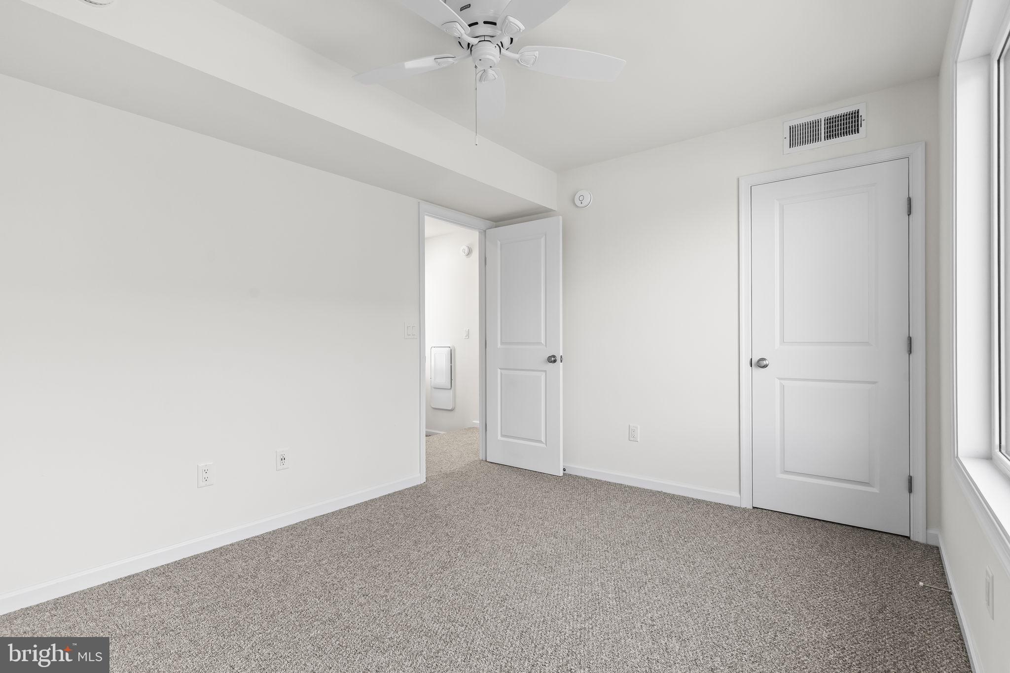 721 60th Place Capitol Heights, MD 20743 - Photo 29 of 33 an empty room with a ceiling fan and a window