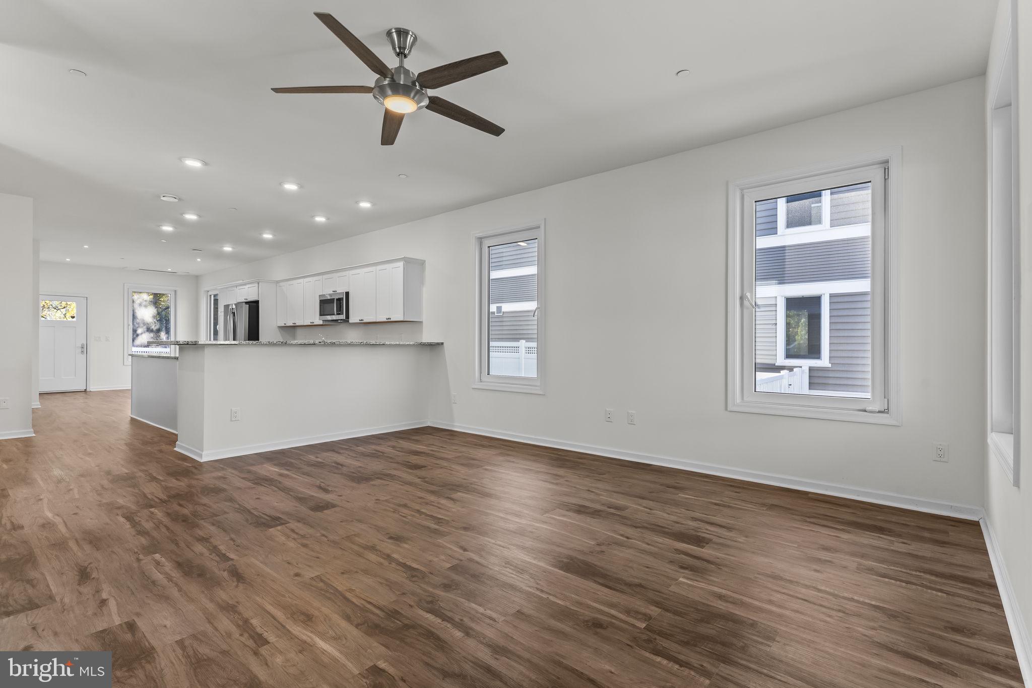 721 60th Place Capitol Heights, MD 20743 - Photo 7 of 33 a view of an empty room with window and wooden floor