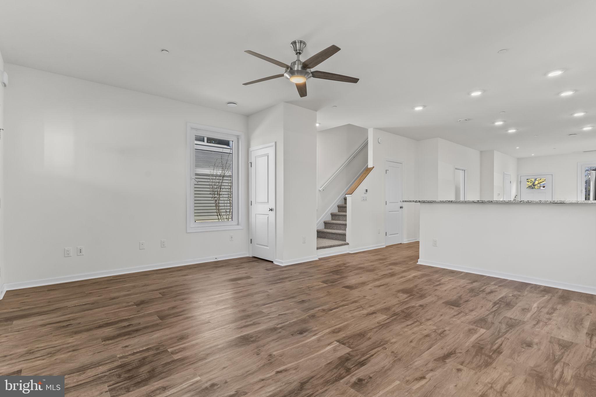 721 60th Place Capitol Heights, MD 20743 - Photo 8 of 33 a view of an empty room with wooden floor and a ceiling fan