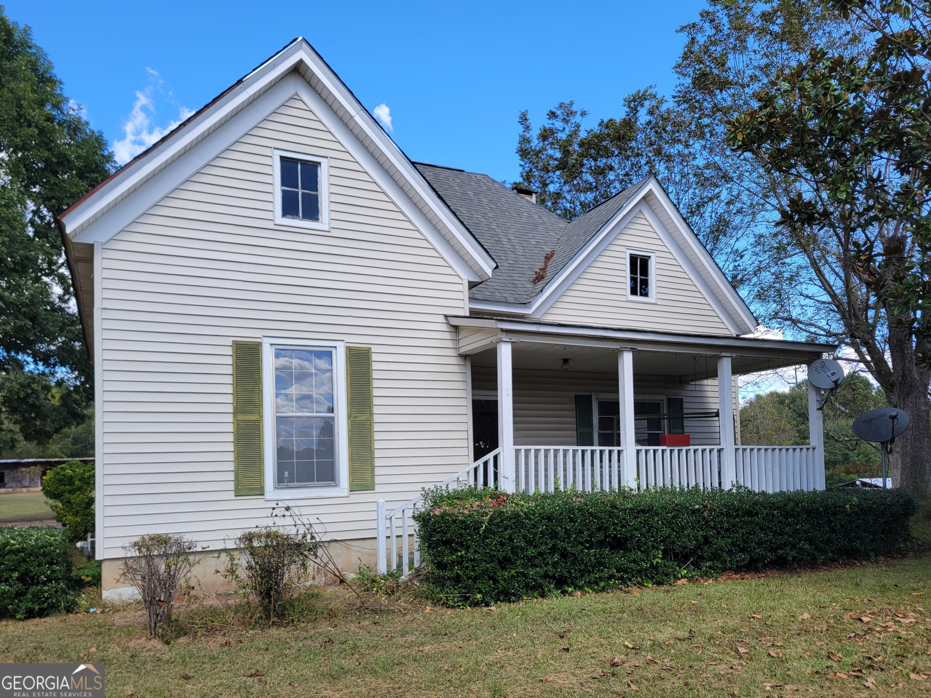 475 Bankhead Highway Winder, GA 30680 - Photo 11 of 11 a view of a white house with a small yard plants and large tree