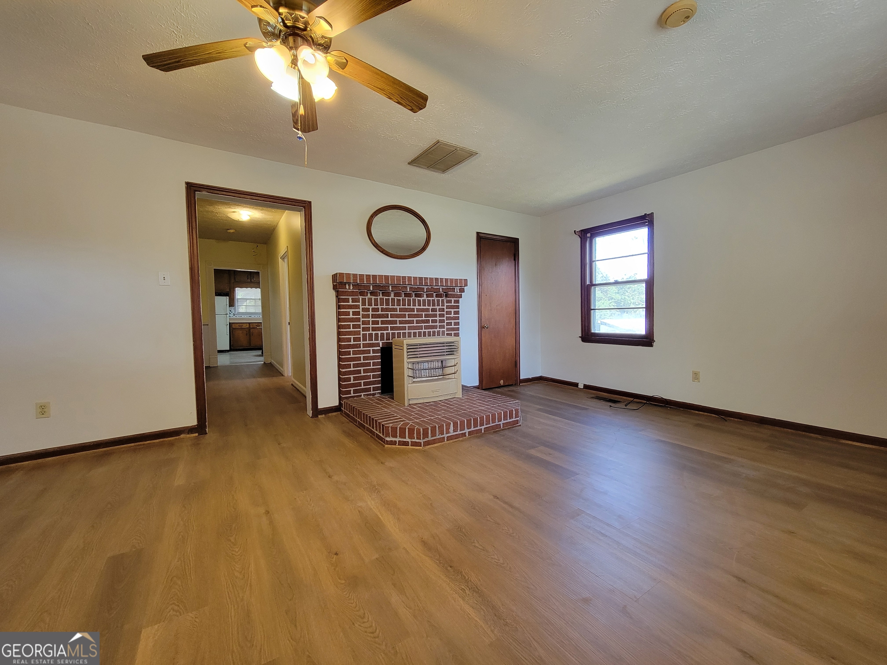 475 Bankhead Highway Winder, GA 30680 - Photo 2 of 11 an empty room with windows and fireplace