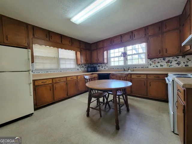 a kitchen with a sink cabinets and window
