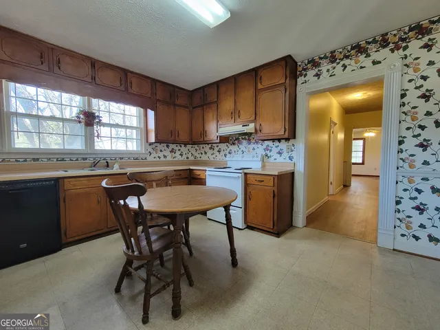 a kitchen with a table and chairs in it