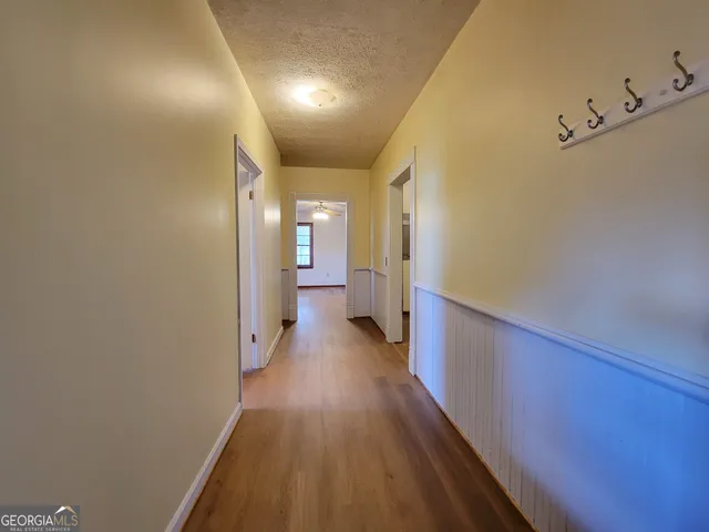 a view of a hallway with wooden floor