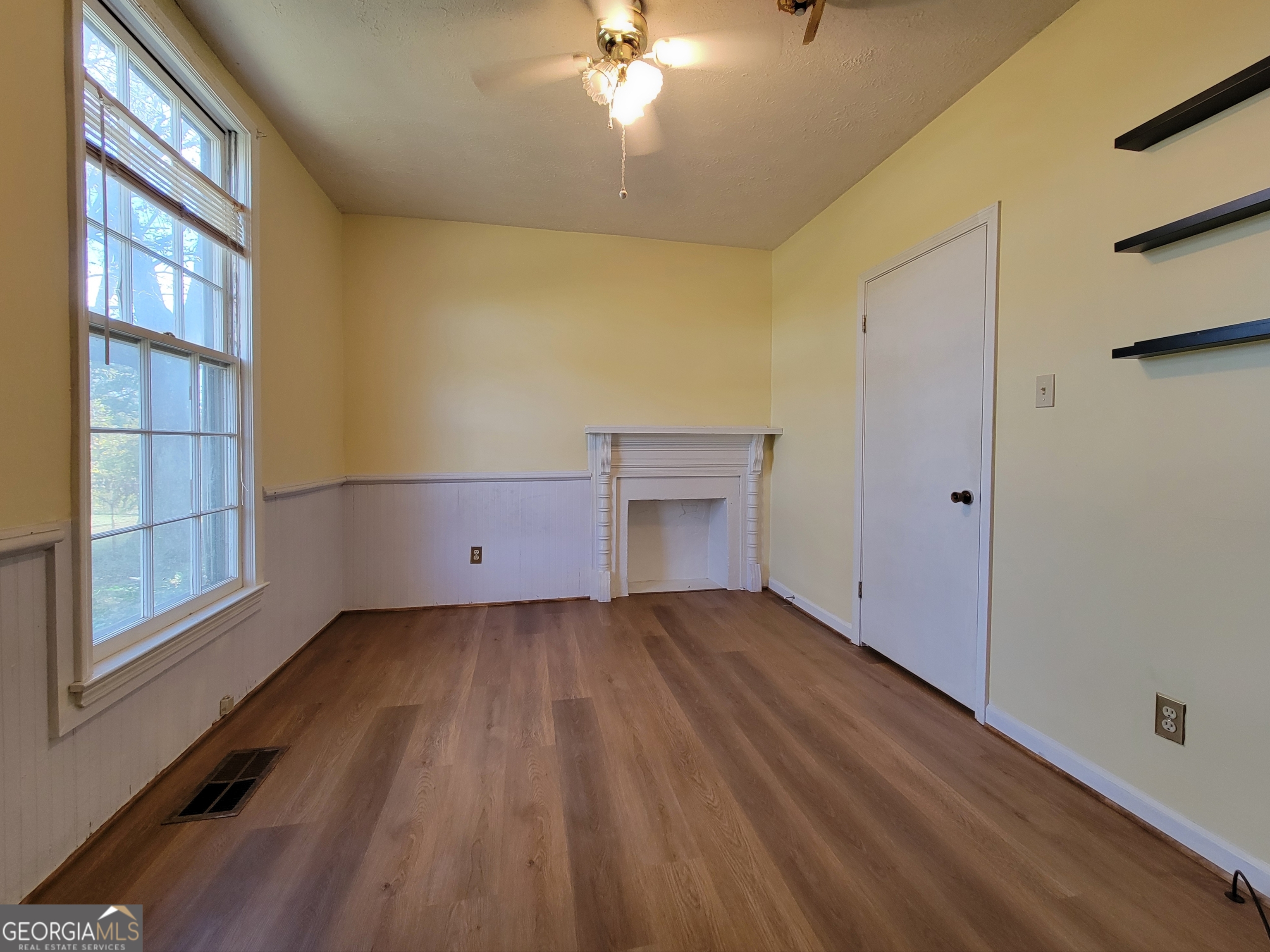 475 Bankhead Highway Winder, GA 30680 - Photo 6 of 11 a view of an empty room with wooden floor and a window