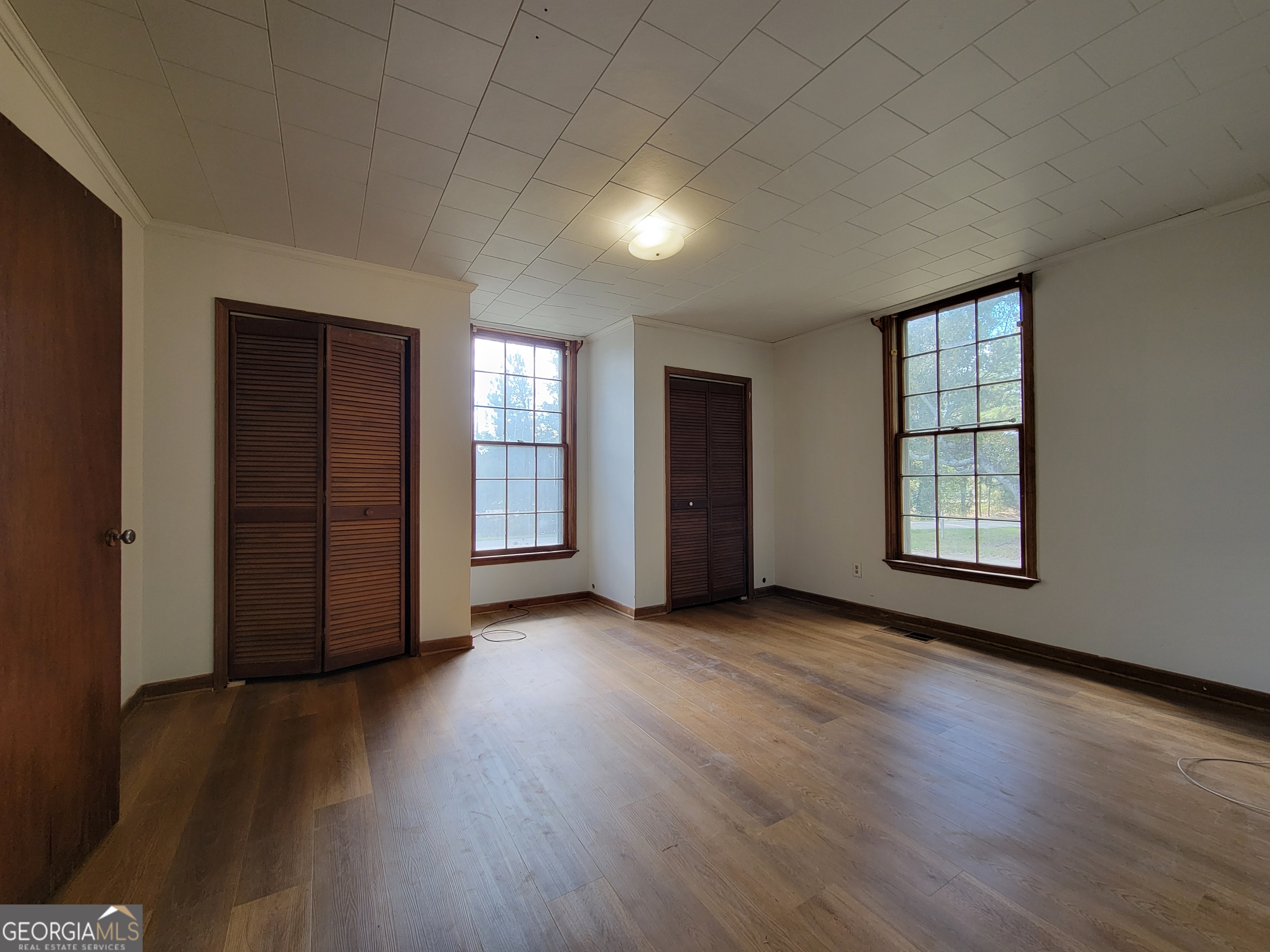 475 Bankhead Highway Winder, GA 30680 - Photo 7 of 11 an empty room with wooden floor and windows