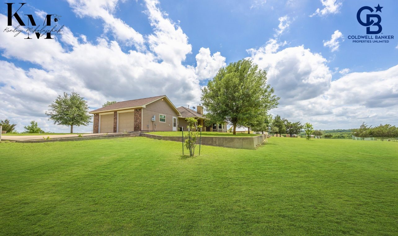 1980 Chappell Ridge Lane Brenham, TX 77833 - Photo 12 of 13 Spacious two-car garage providing secure parking and additional room for storage or workspace.