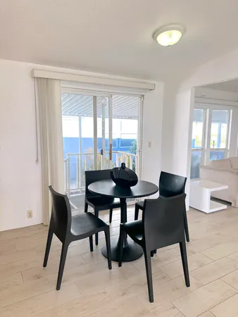 a view of a dining room with furniture and window