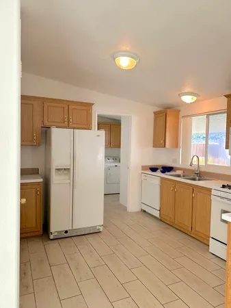 a kitchen with a refrigerator a sink and cabinets