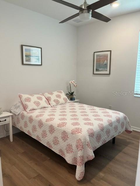 7978 Southwest 90th Terrace Ocala, FL 34481 - Photo 16 of 20 a bedroom with a bed and wooden floor