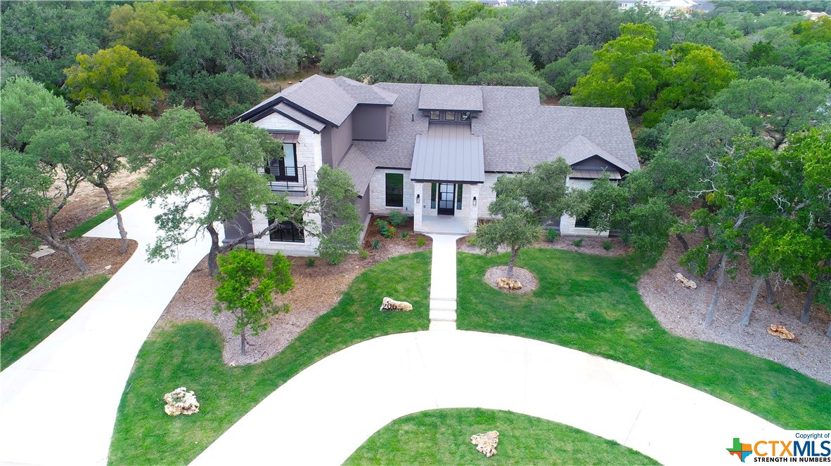 a front view of a house with yard and green space