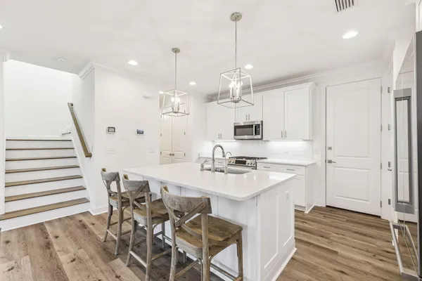 a large kitchen with a table and chairs