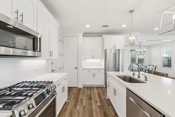 a kitchen with a sink stove and refrigerator