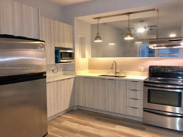 a kitchen with a refrigerator and a stove
