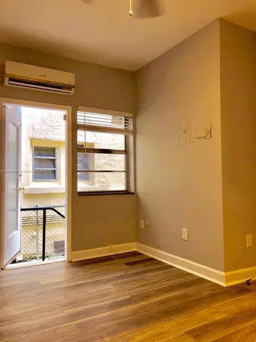 a view of a room with wooden floor
