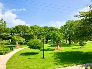 a garden with trees in front of it