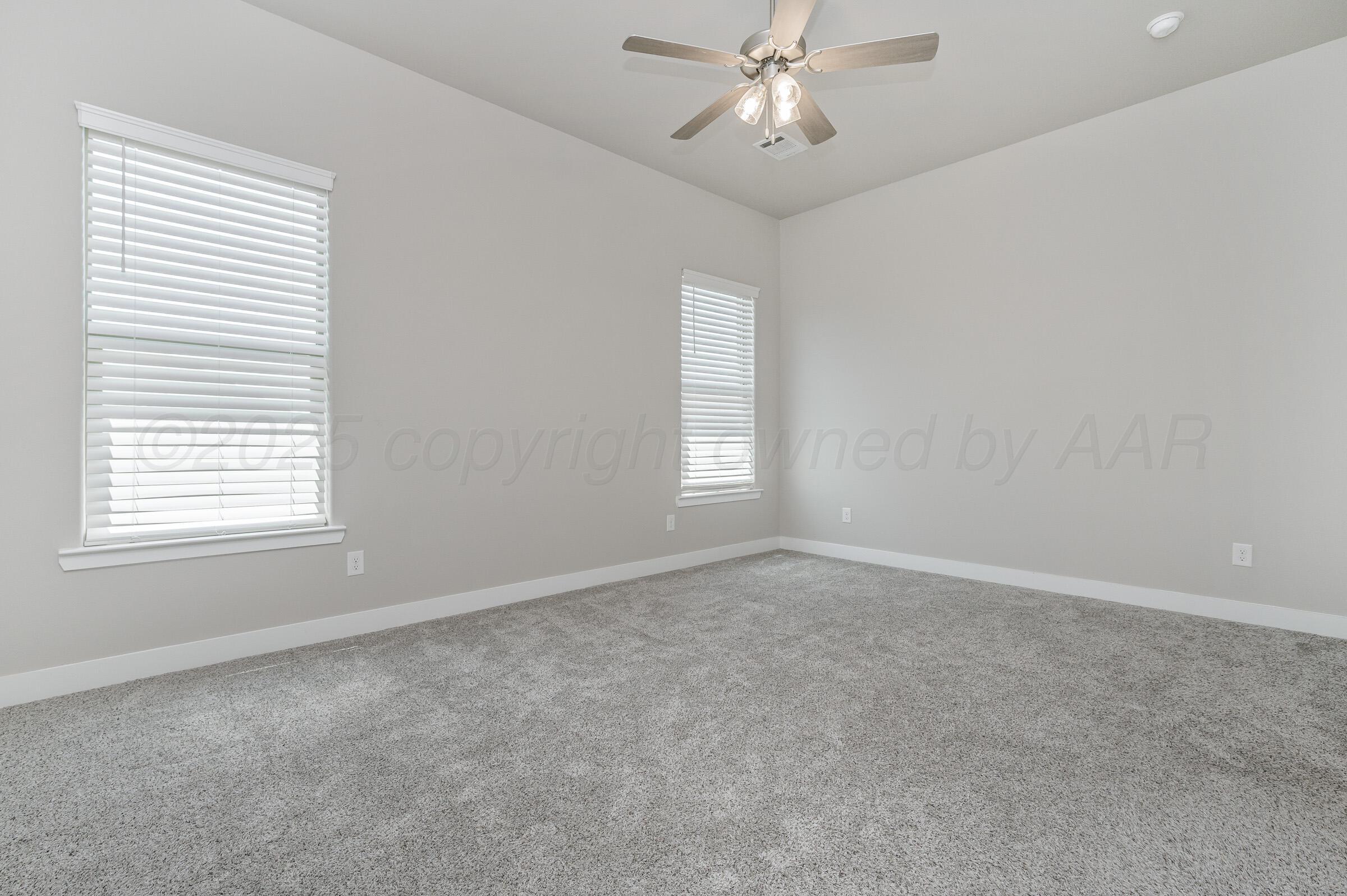 9209 Lexford Drive Amarillo, TX 79119 - Photo 12 of 23 an empty room with a window and a fan