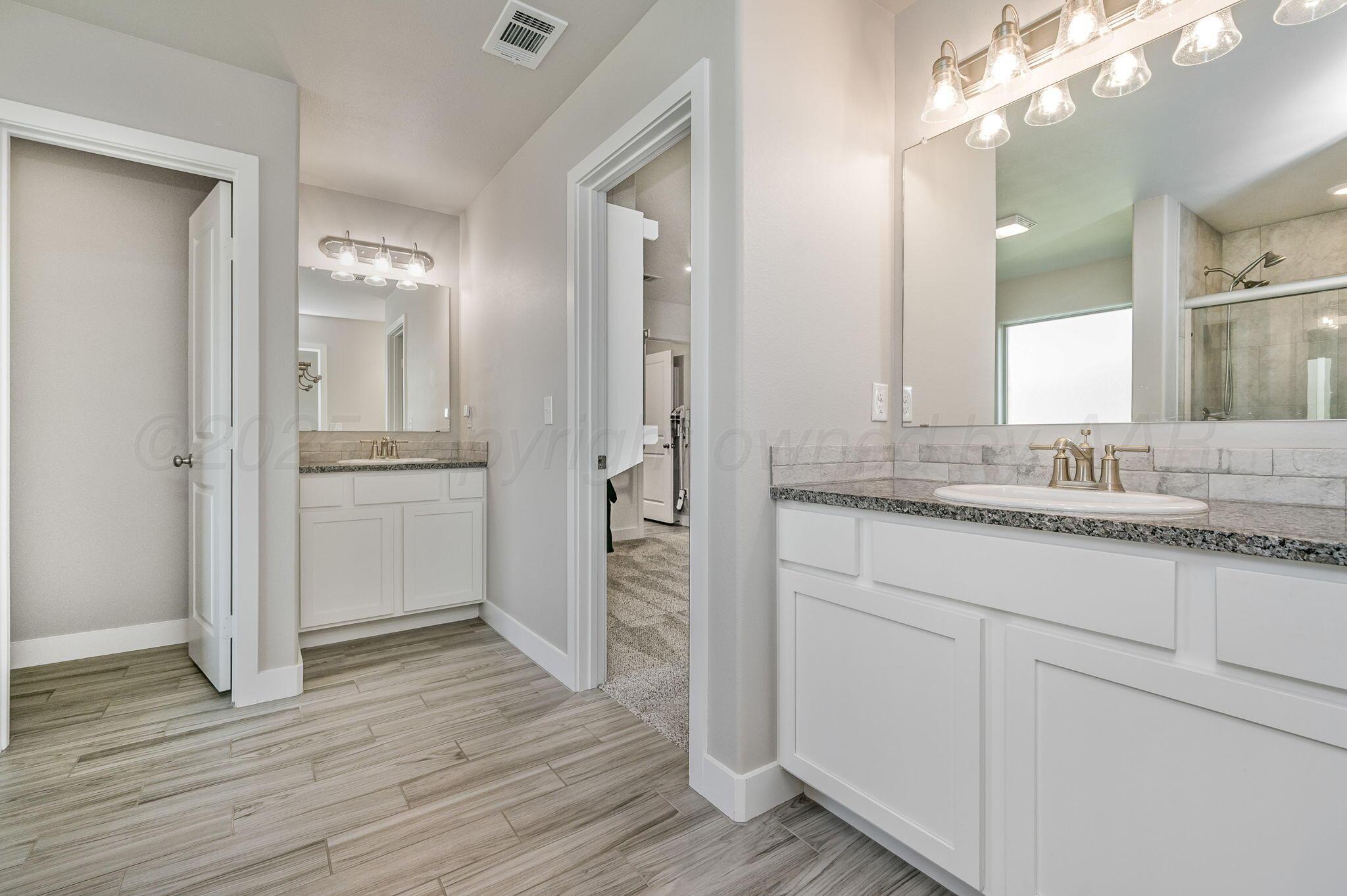 9209 Lexford Drive Amarillo, TX 79119 - Photo 13 of 23 a bathroom with a sink and a mirror