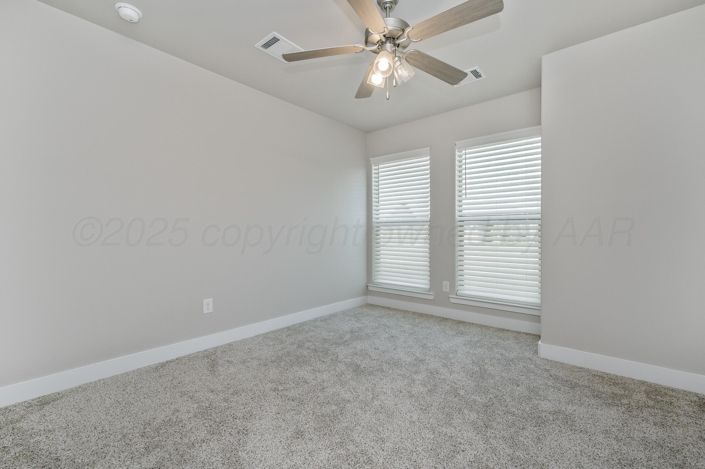 9209 Lexford Drive Amarillo, TX 79119 - Photo 18 of 23 an empty room with windows and fan