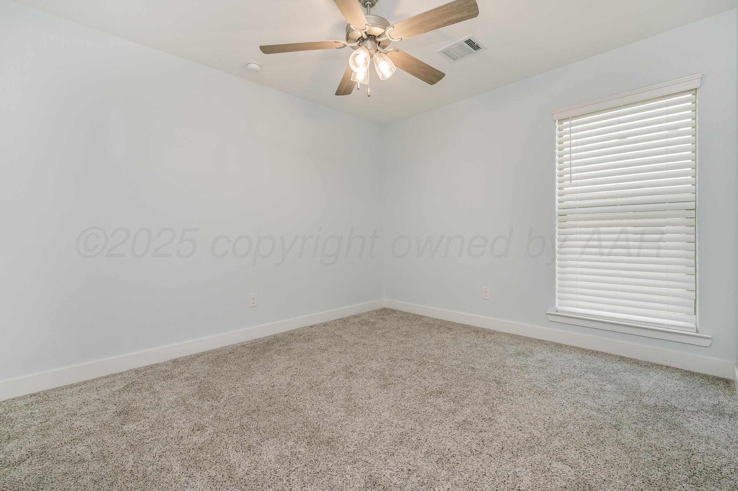 9209 Lexford Drive Amarillo, TX 79119 - Photo 21 of 23 an empty room with a window and a fan
