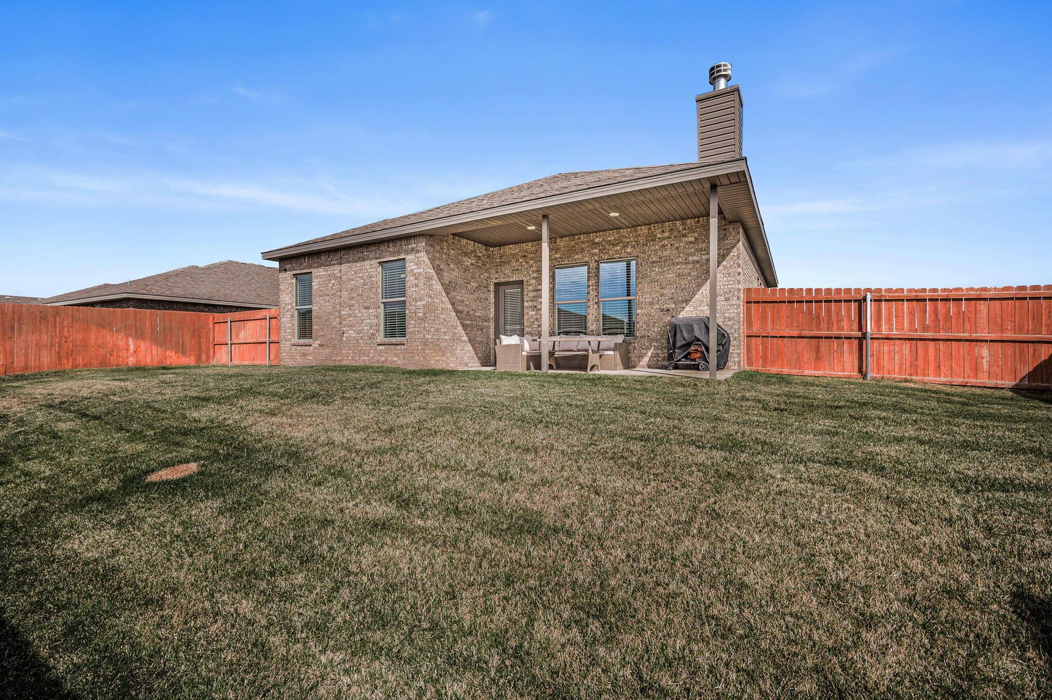 9209 Lexford Drive Amarillo, TX 79119 - Photo 23 of 23 a front view of a house with large garden