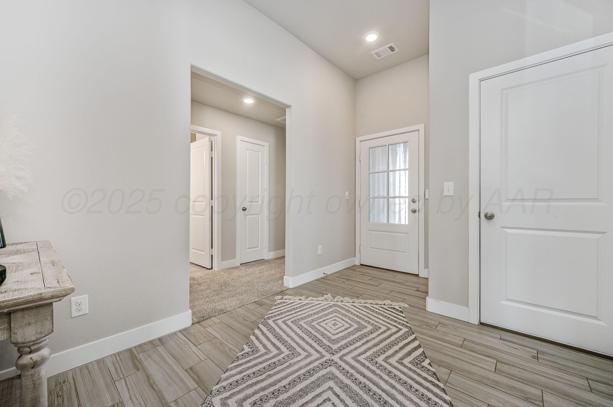 9209 Lexford Drive Amarillo, TX 79119 - Photo 3 of 23 a view of an empty room with wooden floor and closet